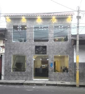 un edificio gris con ventanas en una calle de la ciudad en Fitzcarrald Hotel en Iquitos