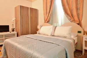 Postel nebo postele na pokoji v ubytování Lucca Relais