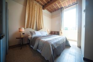 Postel nebo postele na pokoji v ubytování Lucca Relais