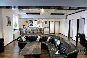 a living room with a leather couch and a table at Suite-Apartment-Essen in Essen