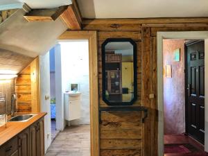 a kitchen with a wooden door and a sink at Riia 141 Apartment in Pärnu +45 photos