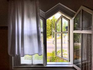 an open window with a view of a street at Riia 141 Apartment in Pärnu