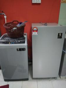 two refrigerators sitting next to each other with a basket on top at Bonda Guesthouse II in Paka