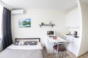 a small bedroom with a bed and a desk at MarySmart in Kyiv