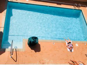 an overhead view of a person in a swimming pool at Sundial Inn in Virginia Beach