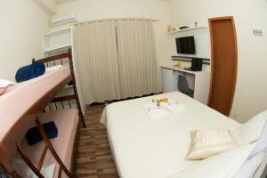 a small room with a bed and two bunk beds at Pousada Fiedler E Anacleto in Penha