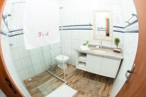 a bathroom with a shower and a sink at Pousada Fiedler E Anacleto in Penha +88 photos