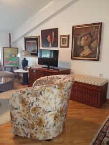 a living room with a couch and a chair at T&A Apartments in Ohrid