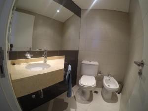 a bathroom with a sink and a toilet and a mirror at Wind Tower in Punta del Este +14 photos
