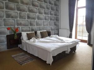 Postel nebo postele na pokoji v ubytování Hotel Camelot