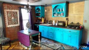 a kitchen with blue cabinets and a purple table at The Relic in Amarillo