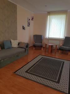 a living room with a couch and a rug at Saule in Daugavpils