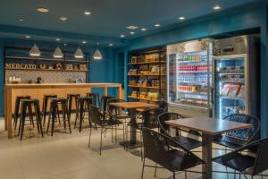 a bar with tables and chairs in a restaurant at Linx Galeão in Rio de Janeiro +26 photos
