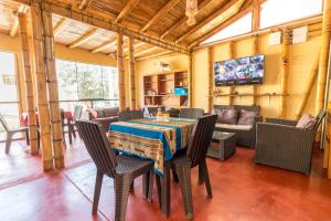 a dining room with a table and chairs at La Casa de Bamboo in Ica