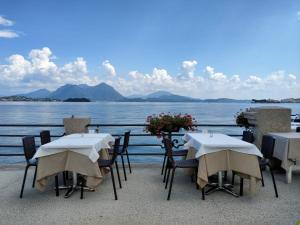 a group of tables and chairs next to the water at Il Planetario in Verbania