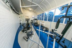 a gym with several treadmills and machines at Dall’Onder Vittoria Hotel Bento Gonçalves in Bento Gonçalves