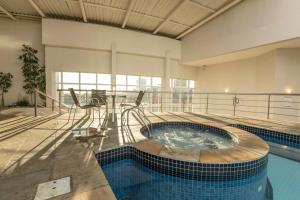 a large indoor swimming pool in a building at Dall’Onder Vittoria Hotel Bento Gonçalves in Bento Gonçalves