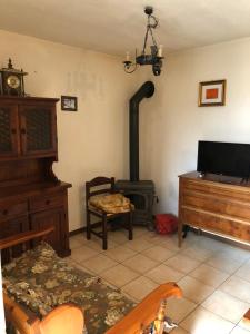 a living room with a wood stove in a room at Via Osvaldo Moretti(complessoShalimar) in Ovindoli
