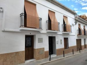 a white building with balconies on a street at Carrasco 4 in Vélez-Málaga