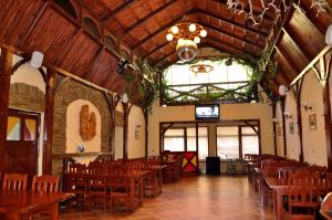 a dining room with wooden tables and chairs at Focus Hotel in Khust