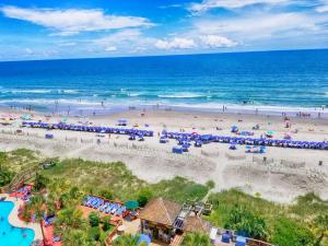 an aerial view of a beach with people and the ocean at Luxurious Ocean Front Views from this 8th Floor Beach Retreat! in Myrtle Beach