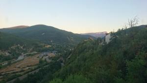 a view of a mountain with trees and a house at Casa Melitona in Castiello de Jaca