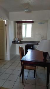 a room with a table and a chair and a window at Valley Hotel in Rosemead