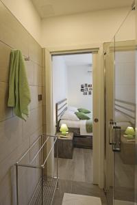 uma casa de banho com um chuveiro e um quarto com uma cama em Timeless City Center Apartments em Dubrovnik