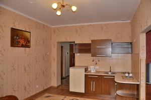 a kitchen with a sink and a refrigerator at Focus Hotel in Khust