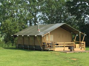 a large tent with a roof in a field at Lincolnshire Glamping in Horncastle