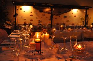 a table with candles and wine glasses on it at Meldi Hotel in Kalkan