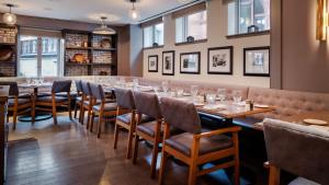 a dining room with a long table and chairs at Hotel AKA Back Bay in Boston
