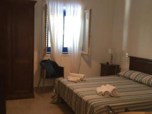 Letto o letti in una camera di Borgo Marino Plemmirio