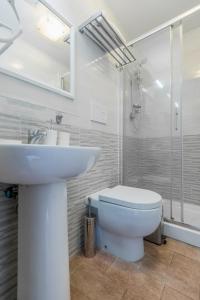 a bathroom with a sink and a toilet and a shower at Walker Rooms in Rome