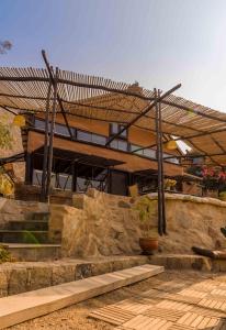 a house with a stone staircase in front of it at Las Cabañas de Tarii in Cieneguilla