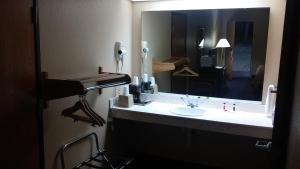 a bathroom with a sink and a large mirror at Super 8 by Wyndham Mount Vernon in Mount Vernon +21 photos
