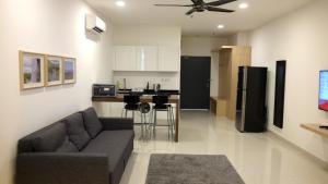 ペタリンジャヤにあるA Suites - Atria Sofo Suites Petaling Jayaのリビングルーム(ソファ付)、キッチン