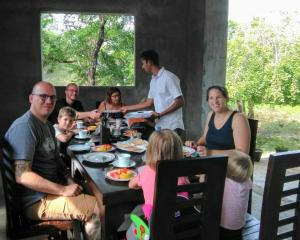 a group of people sitting around a table at My Home Guest in Polonnaruwa