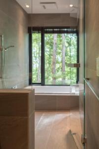 a bathroom with a shower and a window with a tub at Villa El Cielo Hakuba in Hakuba