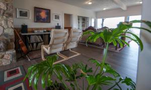 a living room with two chairs and a couch at Shangri-La Oceanfront vacation home in Pender Island