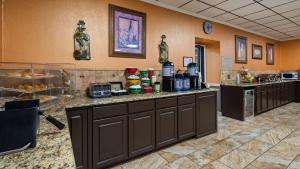 a lobby with a counter with food on it at Best Western Tulsa Airport in Tulsa