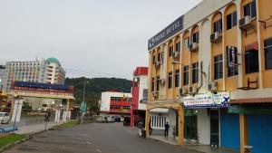 an empty street in a city with buildings at Prime Hotel in Limbang