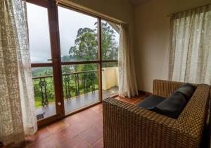a room with a bed and a window at Sherlock in Ooty