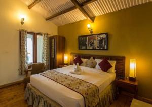 a hotel room with a bed and a television at Sherlock in Ooty