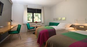 Postel nebo postele na pokoji v ubytování Kysthotellet