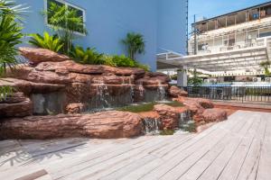 a water feature in a building with a waterfall at P Plus Hotel in Pattaya Central