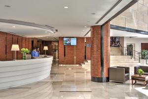 a lobby of a building with a reception counter at Oakwood Hotel & Residence Kuala Lumpur in Kuala Lumpur