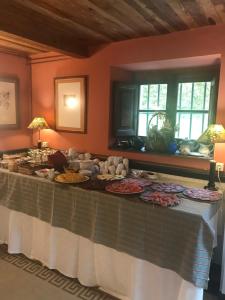 a table with plates of food on it in a room at Hotel Palacio de Libardon in Libardón