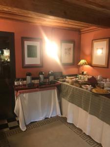 a dining room with a table with food on it at Hotel Palacio de Libardon in Libardón