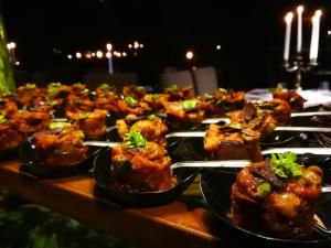 a table with a bunch of food on plates at Vallegrande Nature Resort by Geocharme in Cefalù